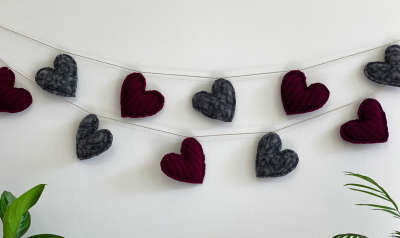 A garland of felted grey and maroon hearts, made from upcycled wool sweaters found at DI.